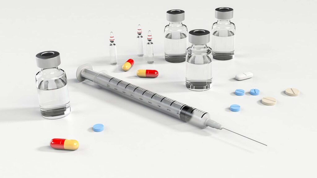A syringe and tablets